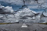 Tattered pieces of sky and ground breaking up in grays and blues