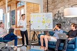 Four people having a meeting on a lounge regarding SEO strategy | Free picture use by Unsplash, www.useproof.com