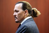 Johnny Depp stands in a Virginia courtroom during his defamation suit against ex-wife Amber Heard.