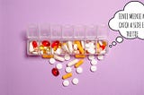 pills scattered around a pillbox
