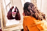 woman looking at her animal self in the mirror