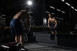 Man looking at himself in the mirror while working out