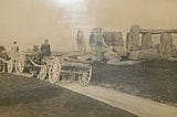 Photo of Stonehenge with horse-pulled carts crossing the henge. c.1885