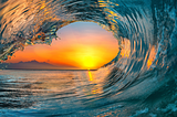a sunset inside an ocean’s wave