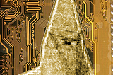 A circuit board with the silhouette of a hooded Klansman, his robes covered in circuit traces.