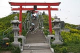 Steps leading up to a shrine at the top of the hill with surrounding gulls