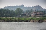 Hampi town by the Tungabhadra River. The river passes through the town and creates a serene atmosphere.