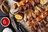 Photo of grilled meat with BBQ sauce and other sauces.