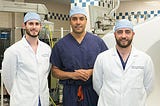 UPMC neurosurgeon David Okonkwo, center, with his current residents Gregory Weiner (left) and David Salvetti