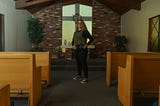 Dr. Ashley Massimino is photographed demonstrating her prison attire inside the Rose of Sharon Prayer Chapel at Biola University in 2024. (Photo by David William Reeve)