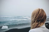 A girl overlooking the ocean.