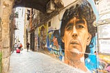 A mural of soccer great Diego Maradona on an alleyway wall near Piazzetta Nilo in the Old Town section of Naples.