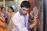 A visually impaired child feeling the painting by Chintamani Hasabnis