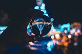 upside down reflection of a city through a glass sphere