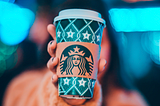 Person holding Starbucks cup to the camera