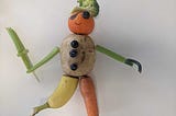 Sculpture of a pirate made out of fruit and vegetables.