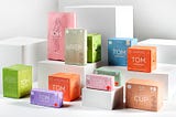 Tom Organic’s product packagings packed onto white cuboids.