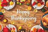 A wood table with words stating “Happy Thanksgiving,” surrounded by images of Thanksgiving food and fruit.