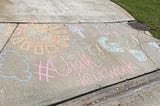 chalk art on sidewalk that reads today is a good day with smiling sun