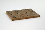 Close up of scrabble pieces that spell out “pace yourself”
