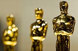 A line of golden Oscar statues.