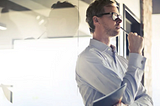 man standing in front of window