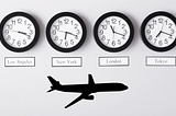 Clocks showing time zones with an illustration of a plane underneath