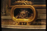 A skull is encased in a golden reliquary