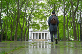John Polonis walking into Grant’s Tomb in the rain and under green leaves