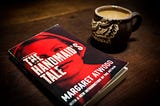 The Handmaid’s Tale book with a cup of coffee