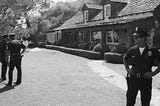 Policemen stand outside the Hollywood home of Roman Polanski and Sharon Tate at 10050 Cielo Drive now a crime scene
