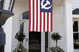 An American flag hanging outside a front door with Soviet hammer and sickle replacing the stars