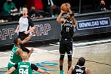 Brooklyn Nets star Kyrie Irving rises up for a jump shot against his former team, the Boston Celtics