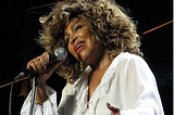 Tina Turner singing into a microphone