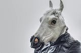 Person in leather jacket wearing donkey mask