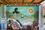 A large mural with a bird flying over the hill sides