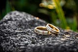 Two wedding rings on a rock