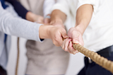 Group of people pulling a rope (tug of war)