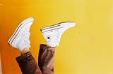 A photo of Converse sneakers and a yellow background