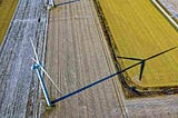 High Angle Photo of Wind Turbine on Field