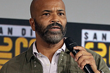 Photo of Actor Jeffrey Wright with a concerned look on his face and speaking into a microphone taken by Gage Skidmore via Wikemedia Commons.