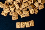 The word HELP made up of alphabet cookies in capital letters. There is a group of randomly stacked cookies at the top of the frame above it.