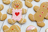 An array of iced gingerbread people on a gray background