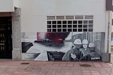 A photo of a mural depicting the camaraderie of the local shipyard workers, taken in Fene, Galicia