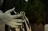 A stylised image of someone wearing a T-shirt and holding a hand over their heart.