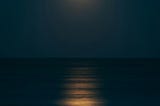 By now the moon had risen over the sea