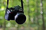 IMAGE: A Nikon DSLR camera hanging from its strap