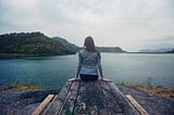 Lady seat at the edge of a river