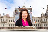 Susan Lee’s headshot on top of the NYC City Hall building.