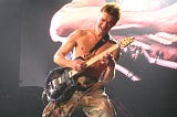Eddie Van Halen playing guitar onstage